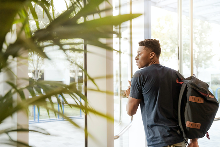 Student walking through facility door